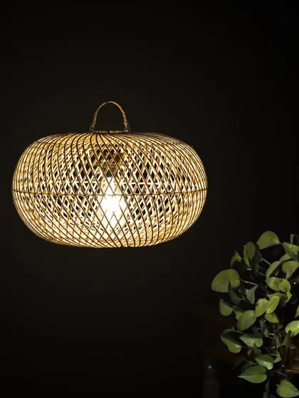 This flattened globe pendant provides a wide, gentle spread of light, ideal for spaces that need a soft, ambient glow. The crisscross rattan weave adds a layer of visual texture.