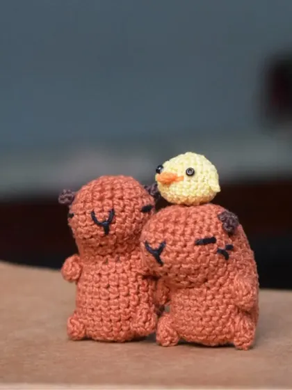 Two little capybaras with a tiny chick on top. This is one of my favorite scenes to set up, showing a moment of calm and friendship between different animals.