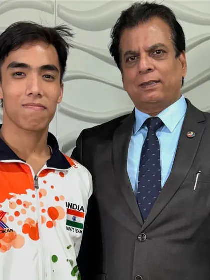 Congratulating a male athlete on his performance at the Commonwealth Championship. Each medal is a victory for India.