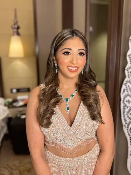 Sera's glowing smile says it all. The makeup enhances her natural beauty while adding a touch of high-fashion glamour.