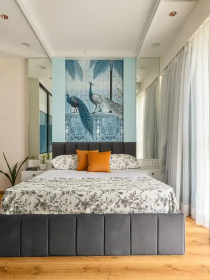 This bedroom is a perfect example of how to use mirrors to create a sense of space. The mirrored wardrobe doors and wall panels make the room feel bright and expansive.