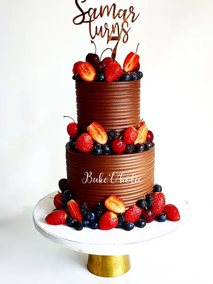 Have a berrylicious day! This two-tier chocolate cake is loaded with the choicest berries of the season: mulberries, morello cherries, strawberries, and blueberries.