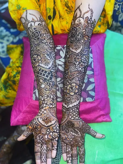 A full view of the bridal henna, showcasing the intricate patterns and full arm coverage.