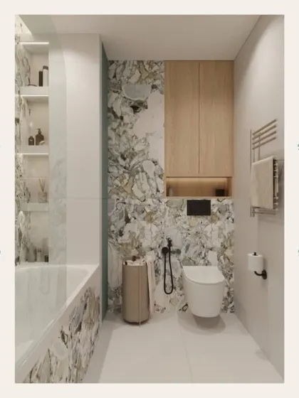 The toilet area features clever storage solutions, with wood-paneled upper cabinets providing a warm, natural element against the cool marble.