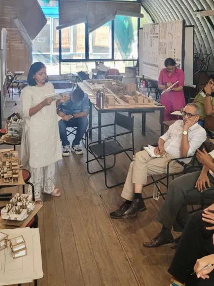 A student presents her work during a final design review at CEPT University. The studio was themed 'Between Utopia and Reality', a core challenge in all architectural endeavors.