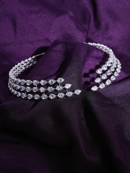 A magnificent diamond choker set against a luxurious purple silk fabric. The lighting is carefully controlled to catch every single stone, showcasing its breathtaking brilliance.