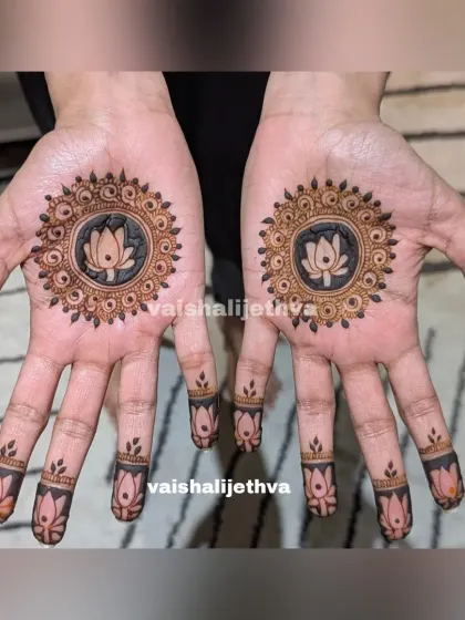 A lovely lotus mandala design. The use of negative space makes the lotus pop, and the finger details complement the central pattern perfectly.