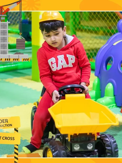 Hard hats on! This little one is ready for a day of construction play on our yellow ride-on dumper truck.