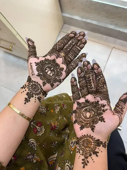 I love adding personal touches to my mehendi designs. In this photo, you can see the name 'Ishant' subtly incorporated into the intricate pattern, making the design unique and special for the client.