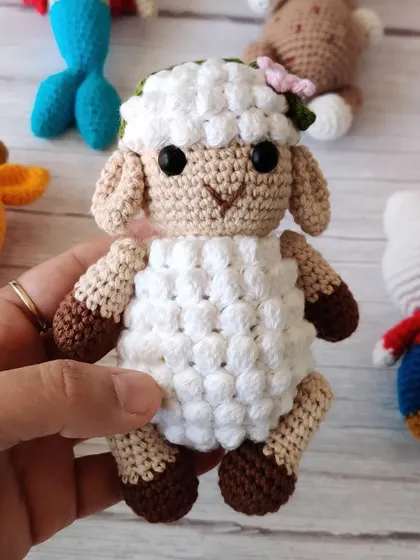 This sweet little crochet sheep with a flower in her hair is so soft and lovely. It's a perfect addition to a calm and gentle nursery theme.