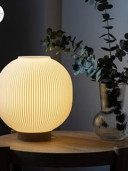 A ribbed ceramic table lamp that adds texture and a soft glow to a bedside table or console.