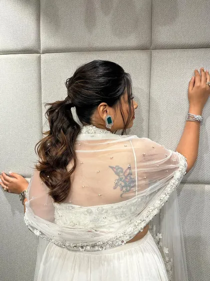A messy ponytail is a great option for a bridesmaid or guest. It's stylish, comfortable, and keeps the hair off the neck for dancing.