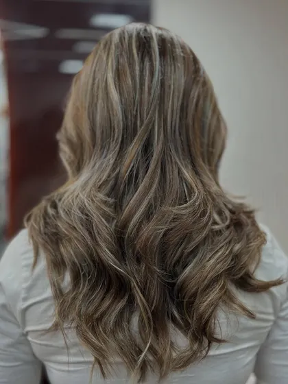 The back view of this ash blonde balayage showcases the beautiful, cool tones and the healthy shine of the hair.