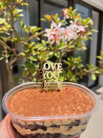 A tub of my classic eggless Tiramisu with a special "I Love You Mom" topper for Mother's Day.