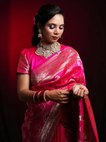 This image shows the full elegance of the pink saree look, highlighting the puff-sleeve blouse and the way the jewellery sits.