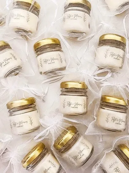 Mini jar candles with custom labels, packed in sheer white organza bags. This is a classic and elegant look.