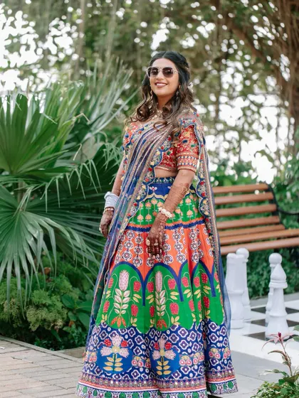 The bride looking cool and chic in sunglasses at her mehendi carnival. The makeup is fun and durable, perfect for an outdoor event.
