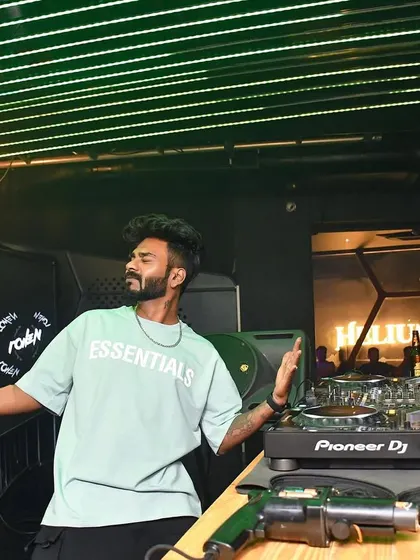 Posing behind the decks at Helium, Pune, in my 'Essentials' tee.