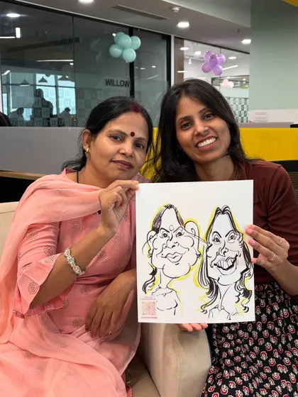 A team duo proudly showing off their caricature. It's a great way to capture office friendships.