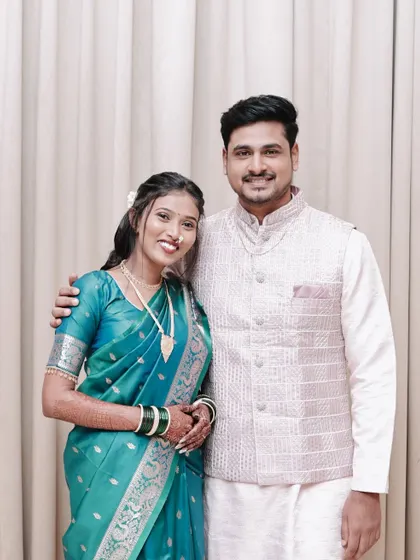 A classic portrait of a smiling, newly engaged couple.
