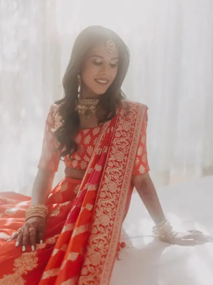 A soft and dreamy bridal portrait of Avni, bathed in beautiful window light. This getting ready shot captures the quiet moments of anticipation before the ceremony.