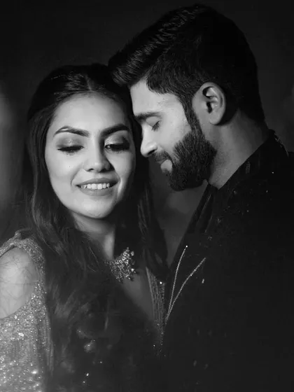 A classic black and white portrait capturing the quiet intimacy and connection between the couple amidst the grand Sangeet celebration.