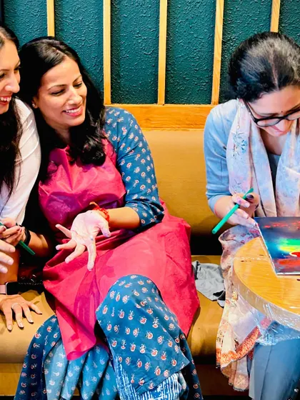 The joy and laughter are contagious. Friends enjoying a creative session together, sharing a moment of fun and connection.