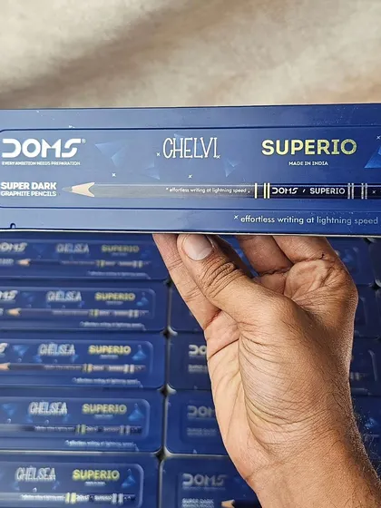 A bulk order of personalized DOMS pencil boxes, ready to be gifted. The name is printed directly on the tin.