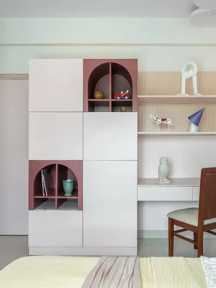 The room includes a spacious study corner with open shelving and a desk, designed to be a perfect spot for homework and creative projects as she grows.