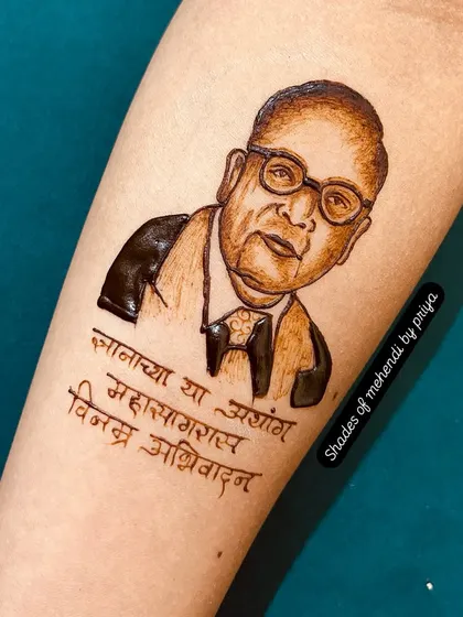 The completed henna portrait of Dr. Babasaheb Ambedkar on the forearm. This type of figure work is perfect for commemorating important dates and showing respect.