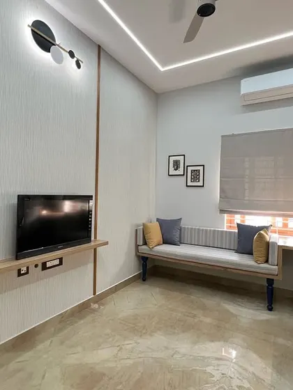 A view of the study room showing the floating TV shelf and a comfortable bench for additional seating. The design ensures the room is versatile, serving as both a workspace and a relaxation area.