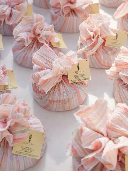 Our customizable dessert hampers, beautifully wrapped in pastel-striped fabric. A charming and unique option for bulk gifting.