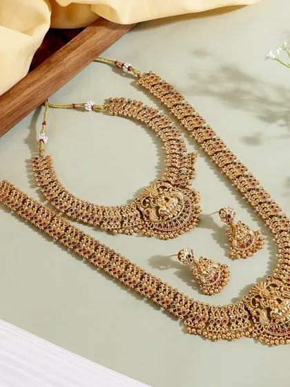 A clean and bright composition of a full temple jewelry set. The light background and soft fabric create a premium feel, showcasing the collection's grandeur.