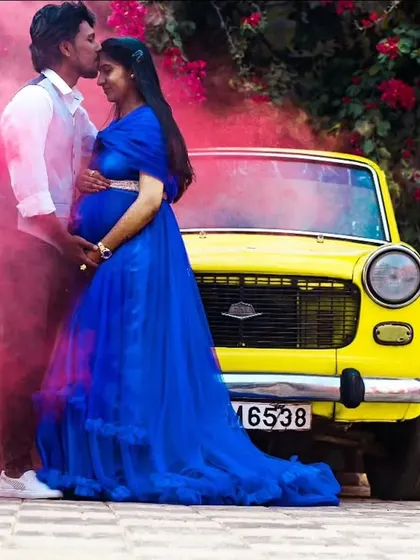 A bold and creative maternity shoot using a vintage car and colored smoke. My royal blue butterfly ball gown provides a stunning pop of color against the yellow car.