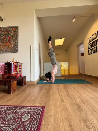 Forearm stand from a wider angle, the whole corridor in frame.