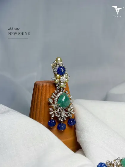 If there was one earring you should carry to all your wedding destinations, it should be this one. This versatile emerald, sapphire and diamond earring is now available at the old gold rate.