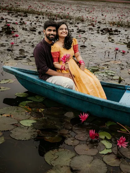 A romantic pre-wedding shoot in a boat surrounded by pink water lilies. This setting in Kerala provides a stunning and unique backdrop for couple photography.