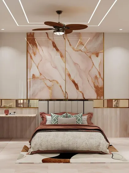 The pink marble-finish panel behind the bed, framed with gold inlay, creates a luxurious and dramatic focal point.