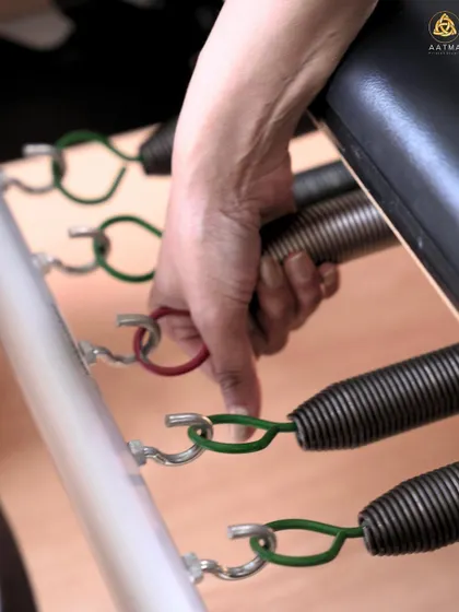 Adjusting the springs on the Reformer is a key part of tailoring the workout. Each color represents a different level of resistance, allowing for endless combinations.