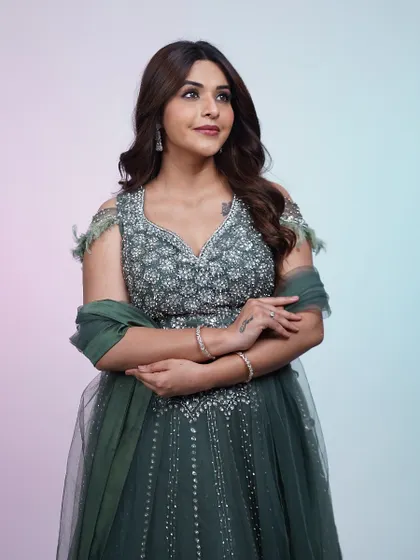 A full view of the dark green lehenga. The A-line skirt and embellished blouse create a classic, flattering silhouette.
