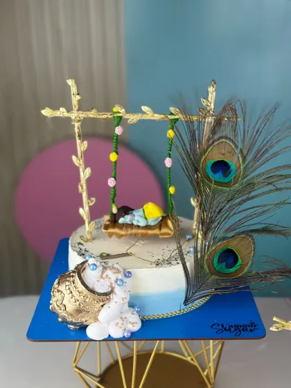 We love bringing festive themes to life with our edible art. This handcrafted Janmashtami cake setup, with its intricate details like the golden swing and peacock feathers, is a sweet offering designed to add a divine touch to your pooja or celebration.