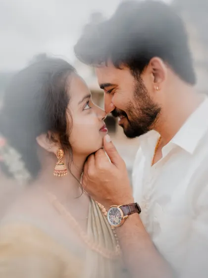 An intimate close-up at the Melkote temple, capturing the groom gently touching the bride's chin. These small, tender gestures are the essence of our storytelling.