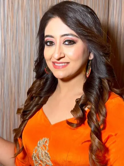 A happy and confident client ready for her event. The makeup is bold enough to match her bright outfit but still feels elegant and polished.