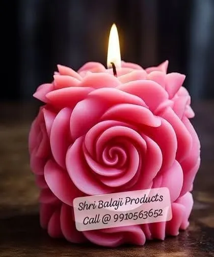 A close-up of a lit, deep pink rose ball candle. The intricate arrangement of petals creates a mesmerizing effect, perfect for a statement decor piece.