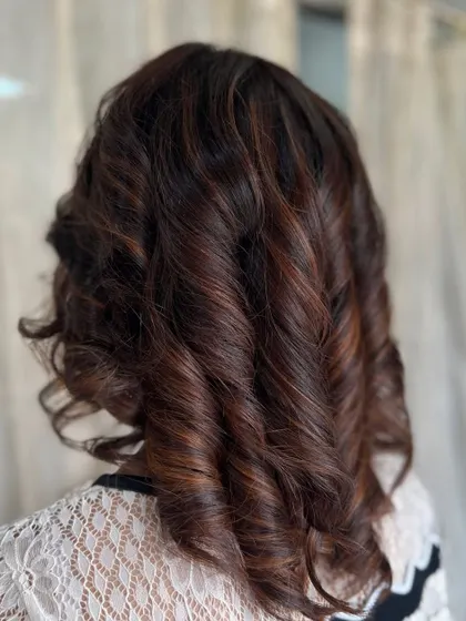 Another view of the versatile and deep brown curls, showcasing their beautiful shape and shine.