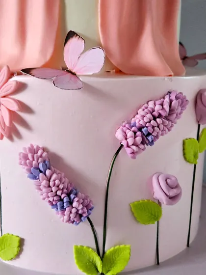 Another detail shot of the piped flowers and edible butterflies, showcasing the delicate and time-consuming work involved.