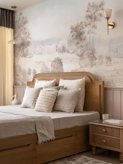 A closer view of the bed with its arched headboard and layered neutral bedding, creating a cozy and inviting atmosphere against the backdrop of the hand-painted mural.