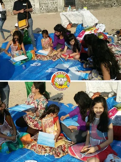 We took our art workshop to the beach! Here, kids and parents are painting by the waves, using the natural beauty of the ocean as their inspiration.