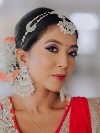 Another beautiful close-up, this time showing the intricate details of the matha patti and large chandelier earrings, which perfectly frame her face.