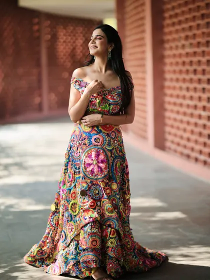 A happy, sun-kissed shot that brings out the joyful colors of the lehenga. I believe in creating looks that feel alive and full of personality.